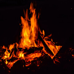 Fire flames on black background, Blaze fire flame texture background, Beautifully, the fire is burning, Fire flames with wood and cow dung bonfire