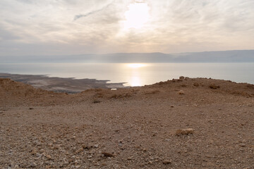 View  from a mountain near the Tamarim stream on the Israeli side of the Dead Sea at sunrise over the Dead Sea and over the mountains on the Jordan side near Jerusalem in Israel