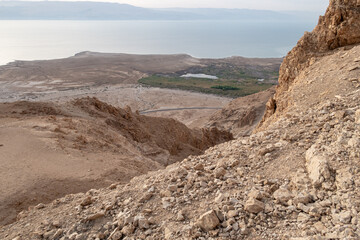 View  from a mountain near the Tamarim stream on the Israeli side of the Dead Sea at sunrise over the Dead Sea and over the mountains on the Jordan side near Jerusalem in Israel