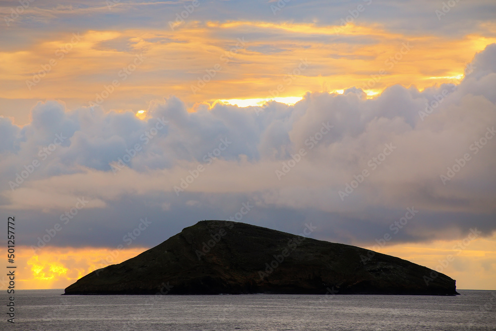 Wall mural silhouette of a small island at sunrise, galapagos national park, ecuador