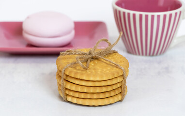 A stack of crunchy cookies on the background of sweet marshmallows and a ceramic cup. Close-up....