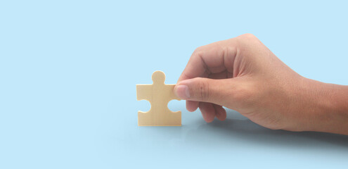 Connecting jigsaw puzzle in  hand