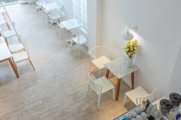 Modern living room interior with comfortable chair, table with colourful decor,