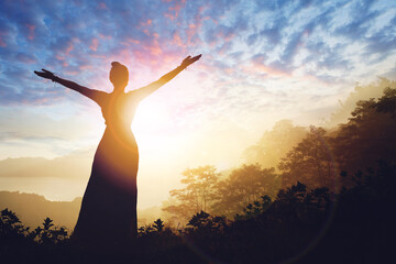 Fototapeta na wymiar Woman successful hiking silhouette in mountains on sunset