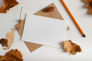 Top view autumn mockup greeting card for holiday invitation. White postcard with empty space for...