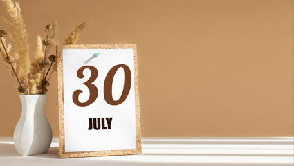 july 30. 30th day of month, calendar date.White vase with dead wood next to cork board with numbers. White-beige background with striped shadow. Concept of day of year, time planner, summer month