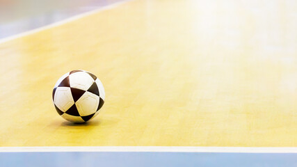Footballs on the indoor gym floor background.