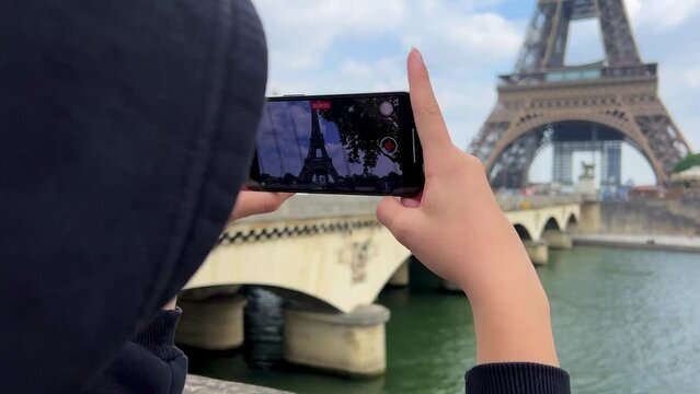 Young woman enjoying beautiful landscape view on the riverside with Eiffel tower from the boat during the sunset in Paris. High quality 4k footage