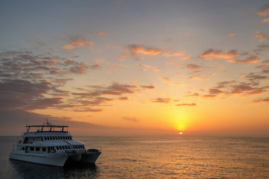 Typical tourist boat anchored near Santa Fe Island at sunrise, Galapagos National Park, Ecuador.
