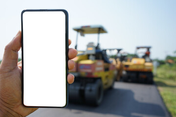 Mobile phone and road construction blur background