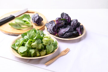 Green and purple cabbage sprout on natural plate, Organic vegetable