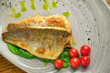 Fried fish fillet with tomatoes