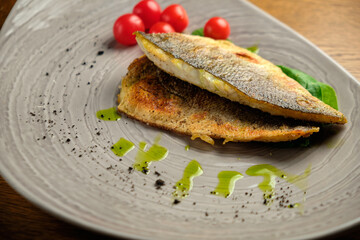 Fried fish fillet with tomatoes