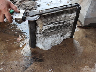 Dirt is caused by cleaning the condenser unit of the car. - obrazy, fototapety, plakaty