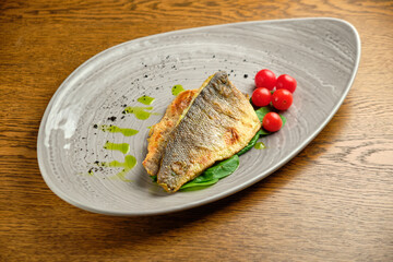 Fried fish fillet with tomatoes