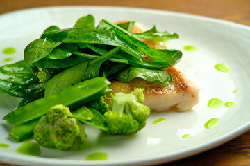 Pike perch fish fillet with spinach leaves