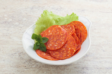 Sliced pepperoni sausage in the bowl