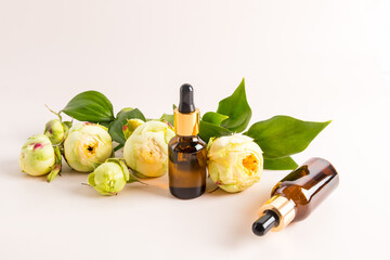 Two glass dropper bottles with a cosmetic natural face and body care product. unique active cosmetics. pastel background.