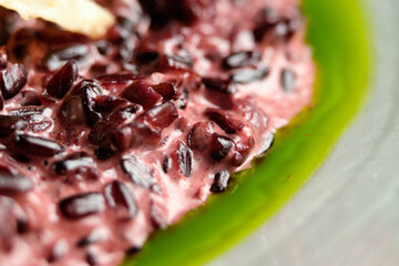 Risotto on a white restaurant plate with cuttlefish ink