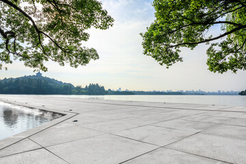 Empty square floor and West Lake with mountain natural landscape in Hangzhou, China.