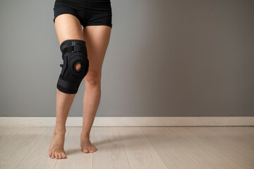 Description: Knee Support Brace on leg isolated on white background. Elastic orthopedic orthosis....