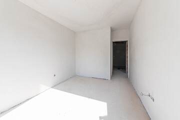 New empty room under construction. Plaster walls. New home. Concrete walls. Interior renovation.