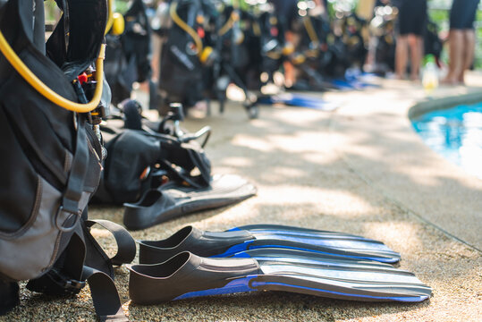 Scuba diving gear laying next to a training pool ready to be used