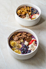 Smoothie Bowl with Granola, Cereal Grains, Chia Seeds, Apple and Blueberries.
