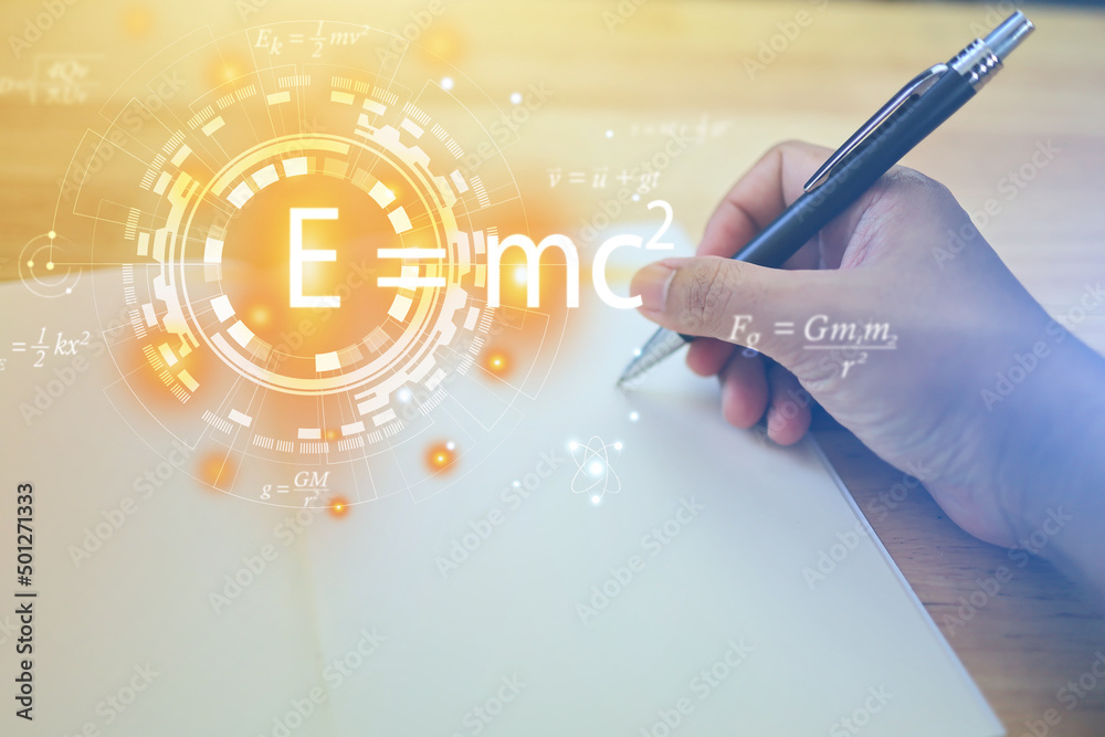 Wall mural hands are writing a notebook with a pen and albert's einstein general relativity equation. physics e