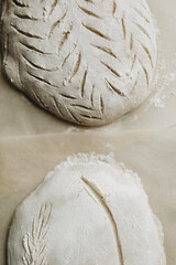 bread dough sprinkled with flour on top. baking craft bread. cut out patterns on bread dough. craft bread close-up.