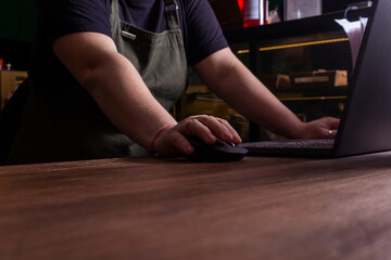 Shop owner working on computer. Coffee shop.