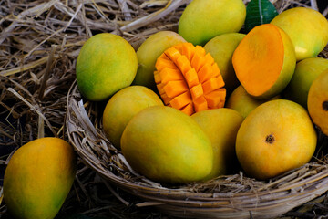 Mango tropical fruit with green leaf, Ripe mango in grass closeup