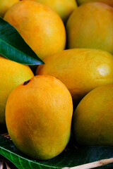 Mango tropical fruit with green leaf, Ripe mango in grass closeup