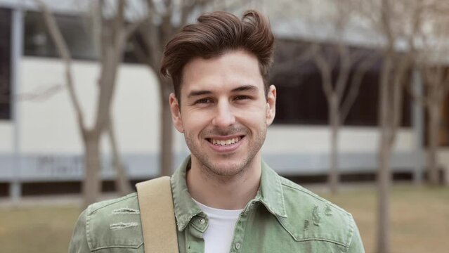 Positive Handsome Young male Student smiling in University campus 