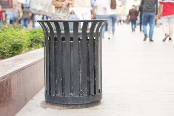 Metal trash bin in a city. - obrazy, fototapety, plakaty