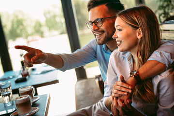 Romantic loving couple drinking coffee, having a date in the cafe.