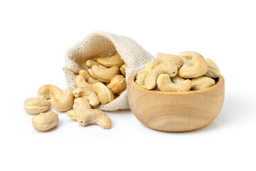 Cashew nuts in wooden bowl and sack bag isolated on white background.