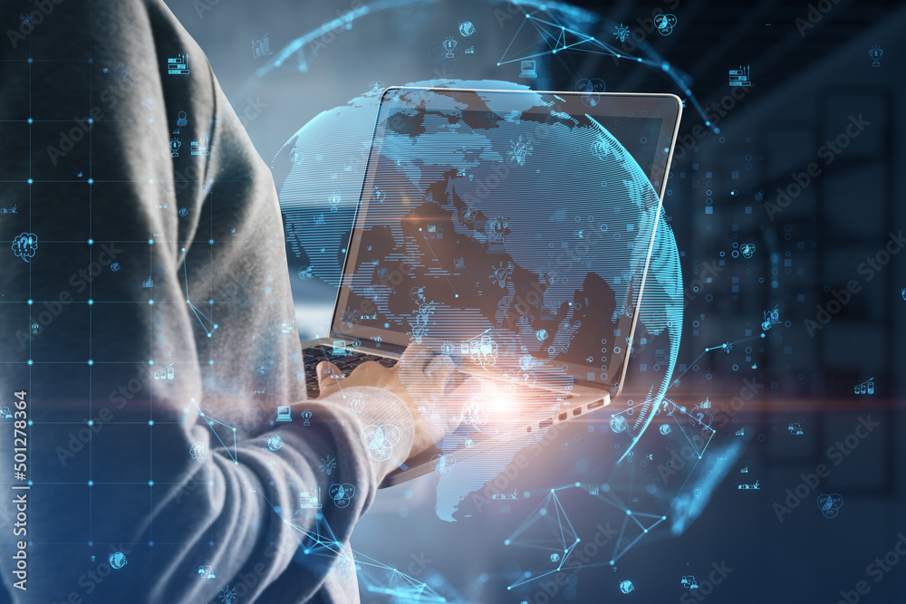 Poster close up of hand using laptop with glowing polygonal globe with social icons on blurry office interi