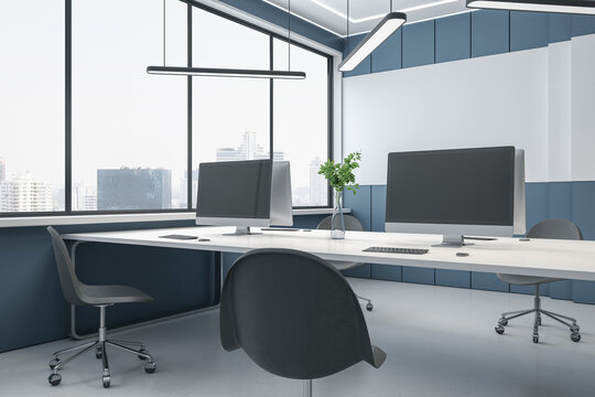 Bright concrete coworking office interior with panoramic city view, empty mockup computer monitors on desks and chairs. 3D Rendering.