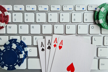 Playing cards casino chips and computer keyboard closeup