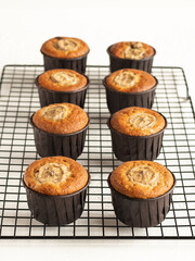 Banana cupcakes in the brown paper baking forms on the cooling rack