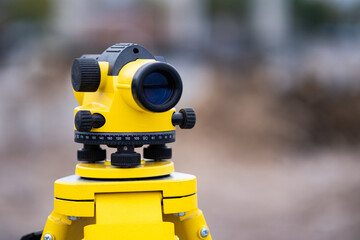 Yellow theodolitYellow theodolite on a tripod with a blurred background. Geodetic measurements.e on...