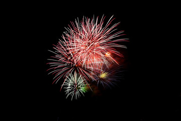 Fototapeta premium Colorful fireworks in the night sky celebration, color image, colors, exploding, firework display, illuminated, majestic, multi-colored, night, no people, outdoors, sky, spark, vertical, photography