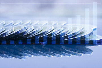 Double exposure Rows of coins of graph on the table,finance and business concept, in blue tone...