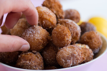 The fluffy pancakes with lemon on a pink background.