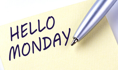 Sticky Note Message HELLO MONDAY with pen on the white background