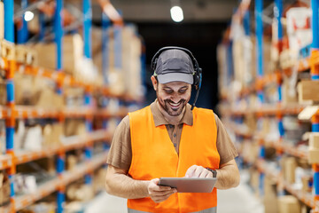 A delivery center worker with voice picking headset scrolling on the tablet.