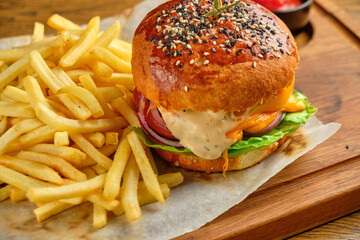 French fries next to a burger lying