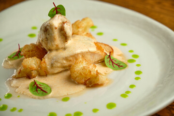 Chicken breast fillet with white sauce and olive oil