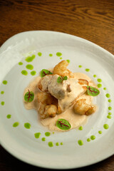 Chicken breast fillet with white sauce and olive oil